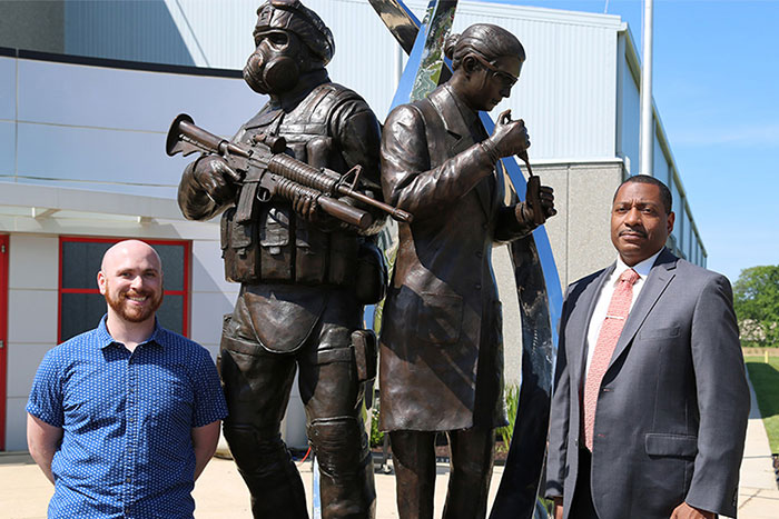 Statue 3D Designer and Chemical Biological Center Director stand next to the new statue at Edgewood's Chemical Biological Center