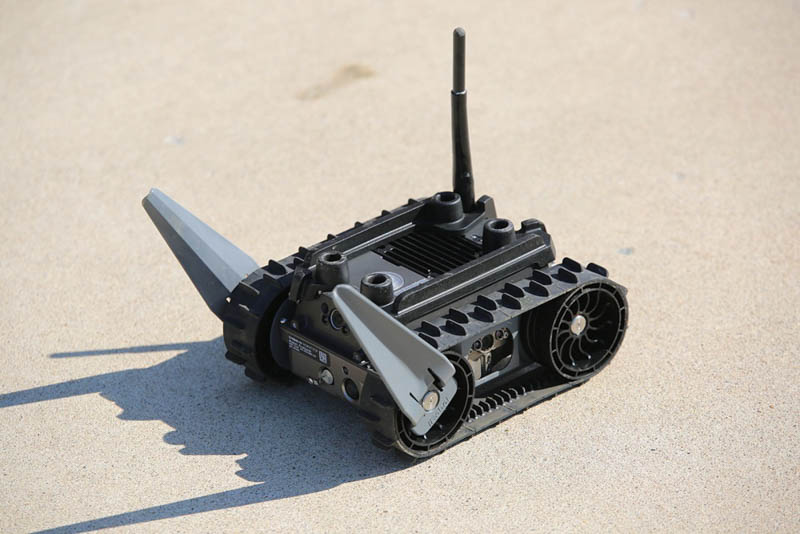 Small lightweight tracked wheeled robot on ground