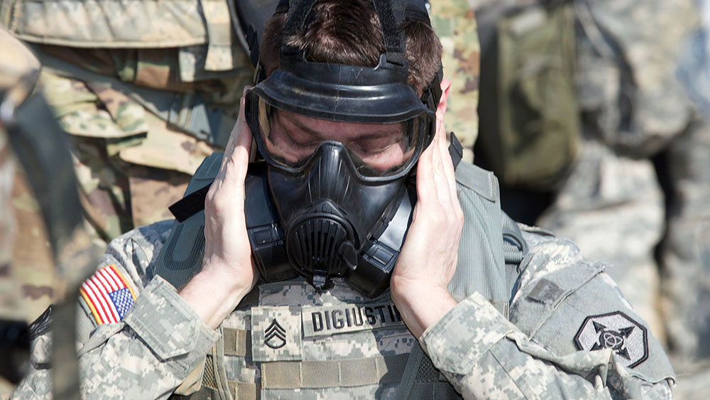 Soldier dons gas mask