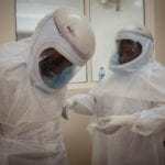 Health care workers in protective suits