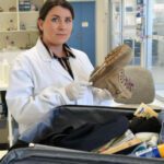 Dr. Young swabs the bottom of a desert combat boot