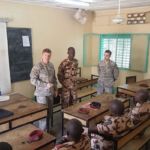 Staff Sgt. McGuire presents a coin to the honor student of a counter-improvised explosive device training event at DIRGENIE Battalion Headquarters. C-IED Training in Chad